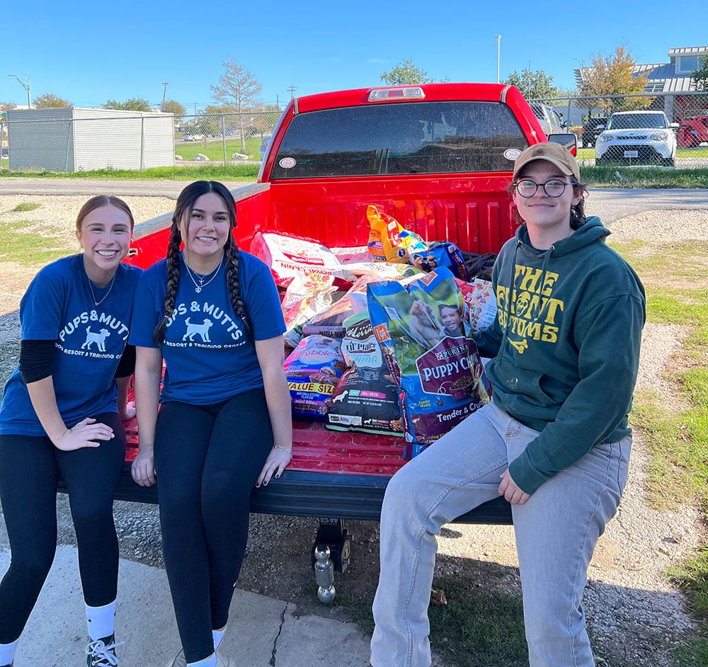 Pups and Mutts Employees with Giving Tree Donations